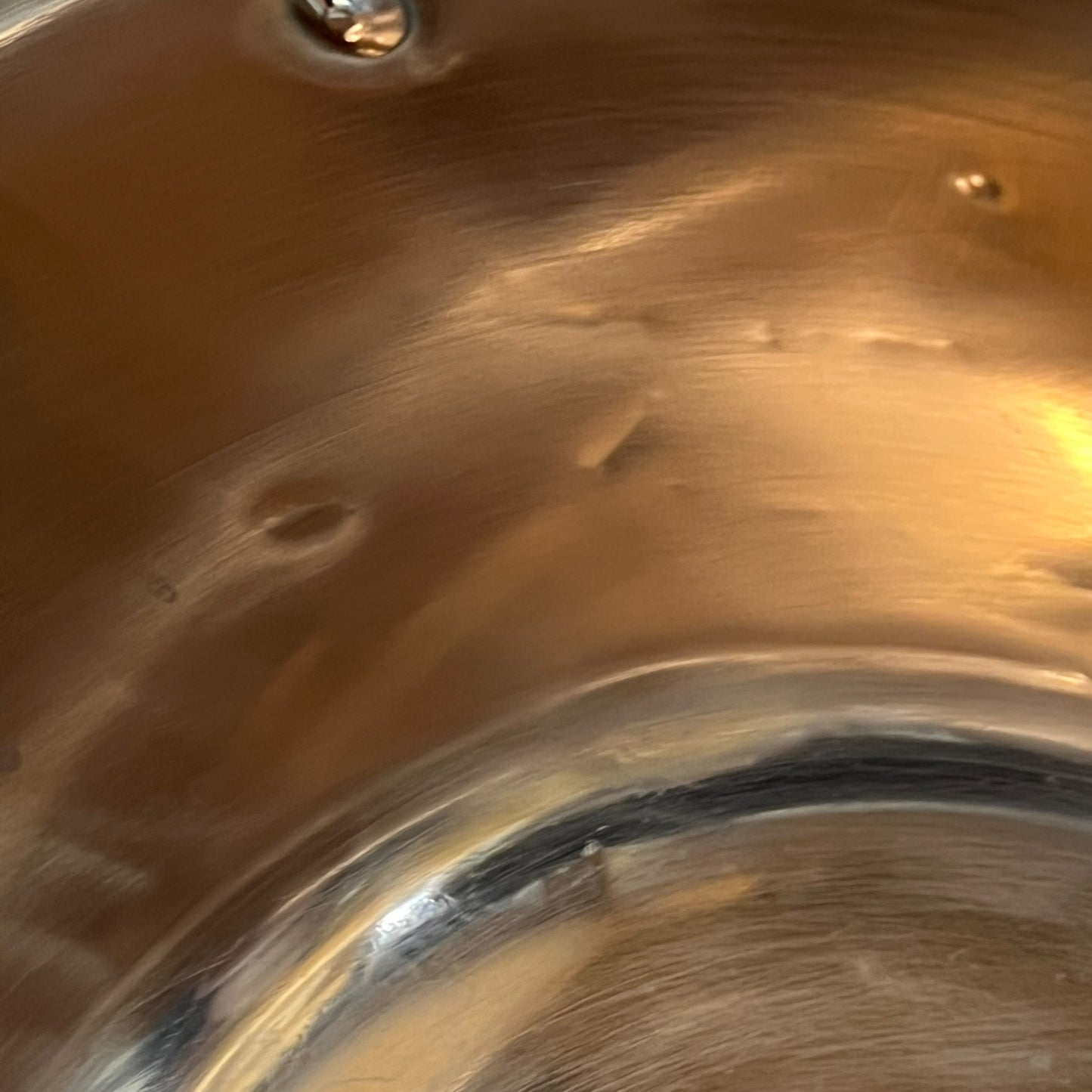 Close up of a French copper bathroom basin on a white background