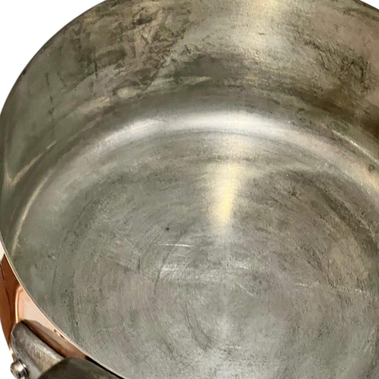 Close-up of copper cookware with iron handles on a white background
