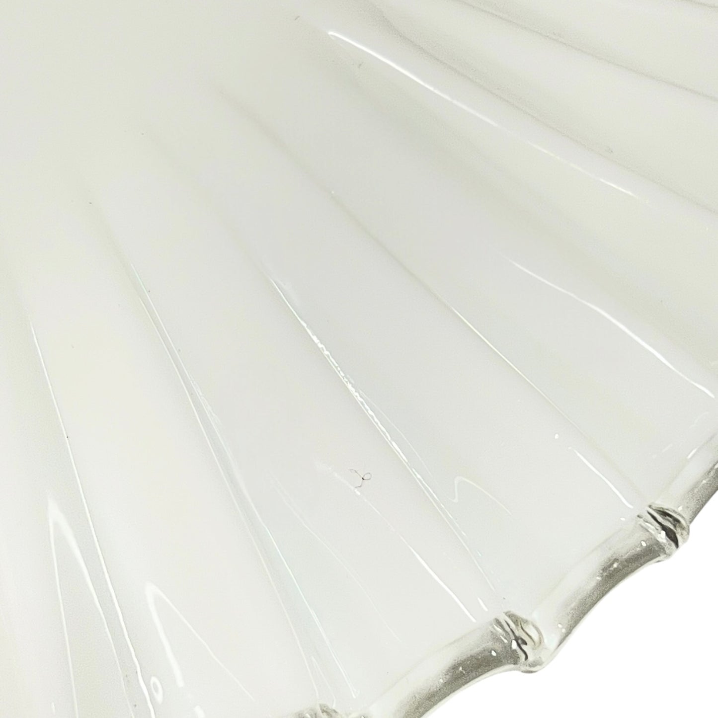 Close up of a White scalloped-edge glass lampshade with brass fitting on a white background, for a period living room styling or vintage home decor 