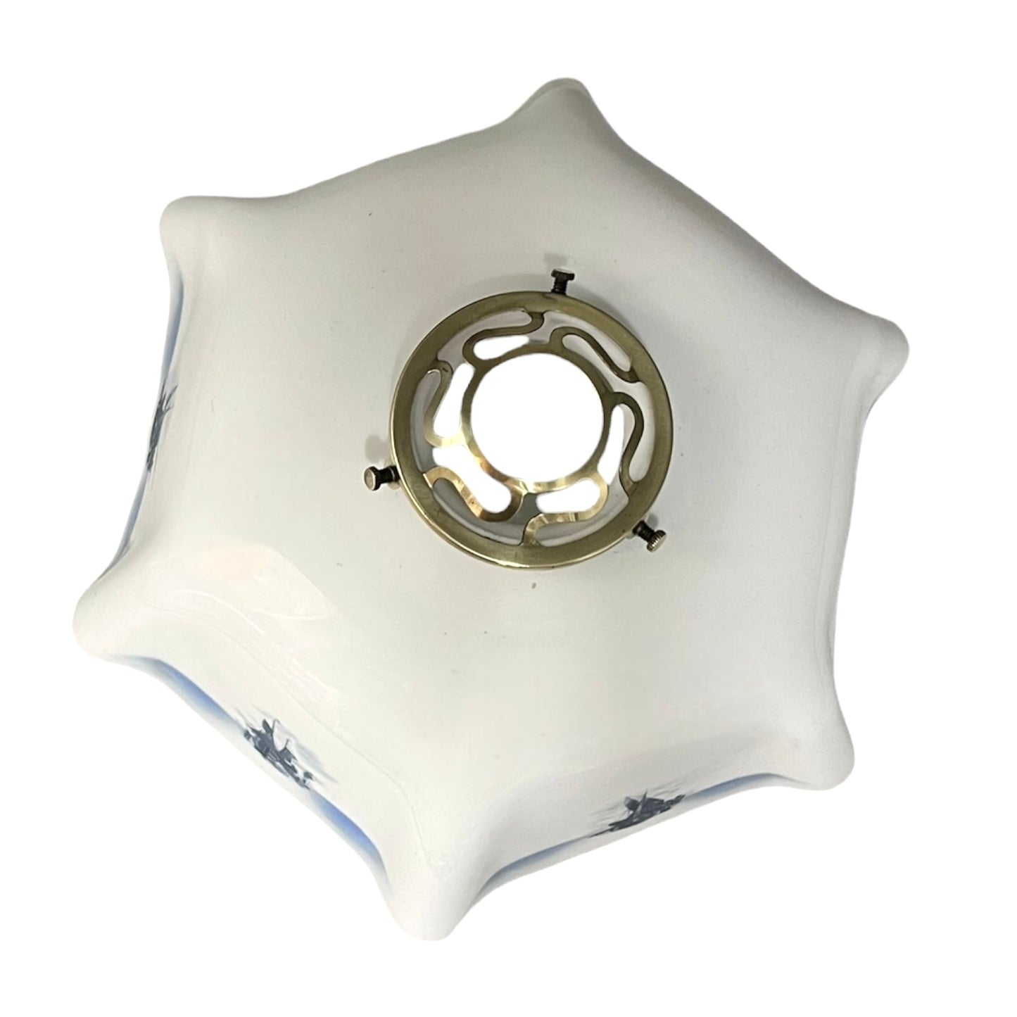 Close up of a white glass lamp shade with decorative design on a white background