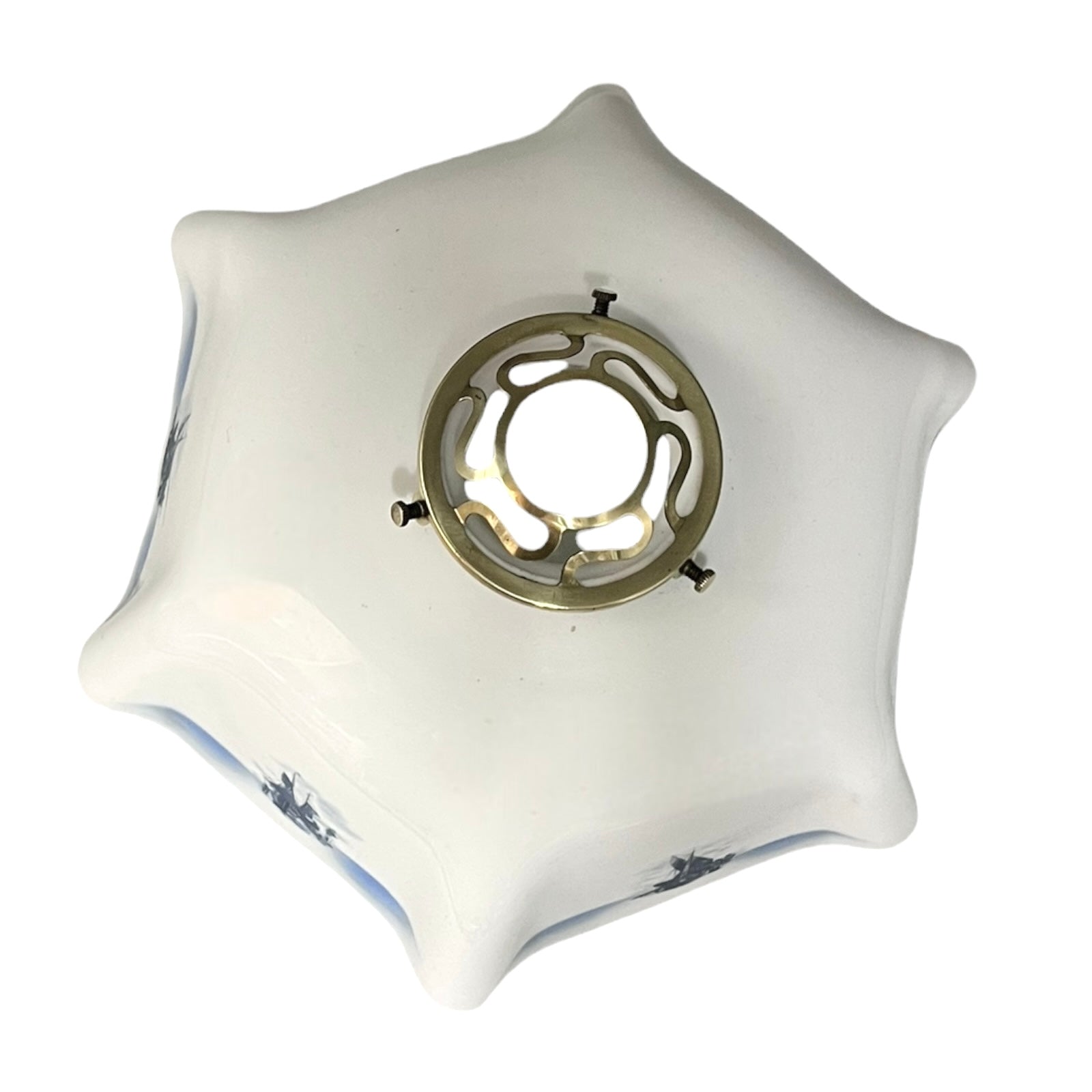 Close up of a white glass lamp shade with decorative design on a white background