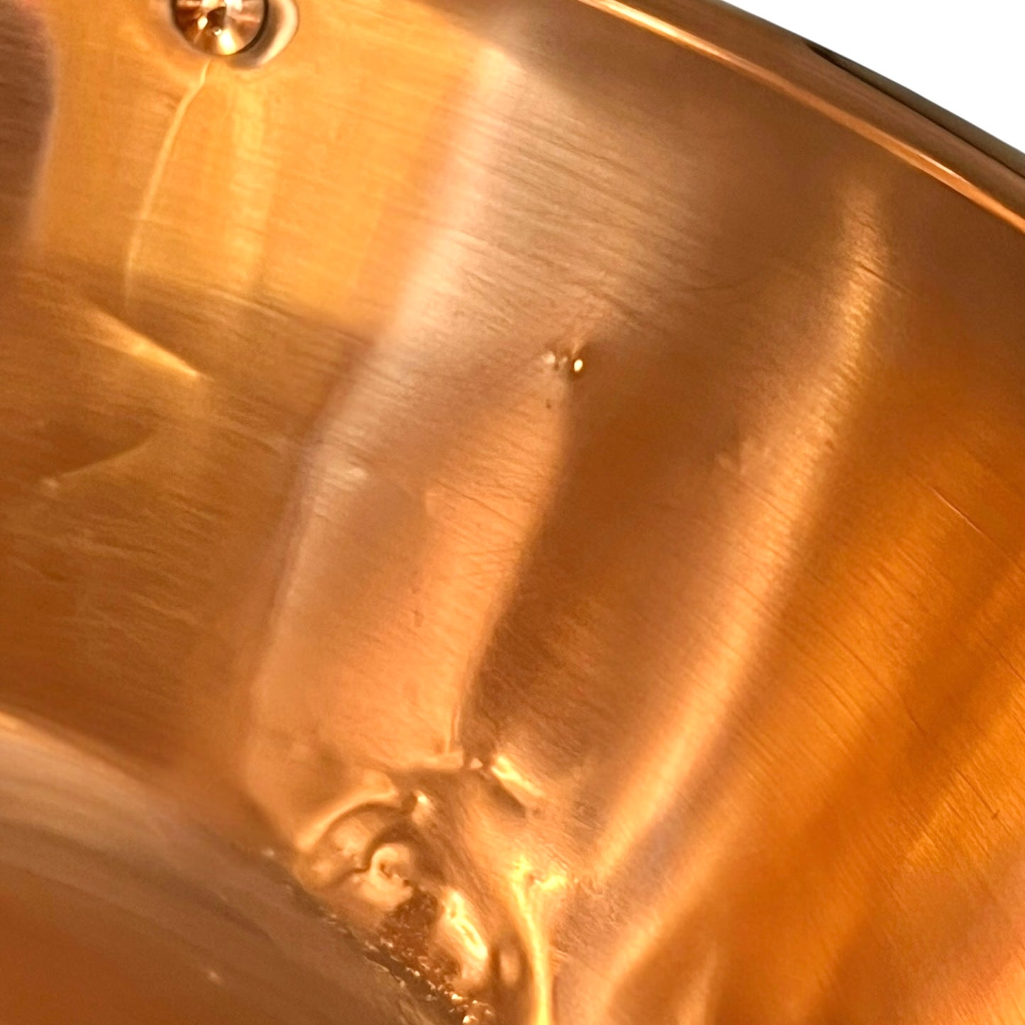 Close up of a French copper bathroom basin on a white background