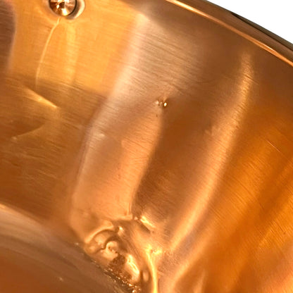 Close up of a French copper bathroom basin on a white background
