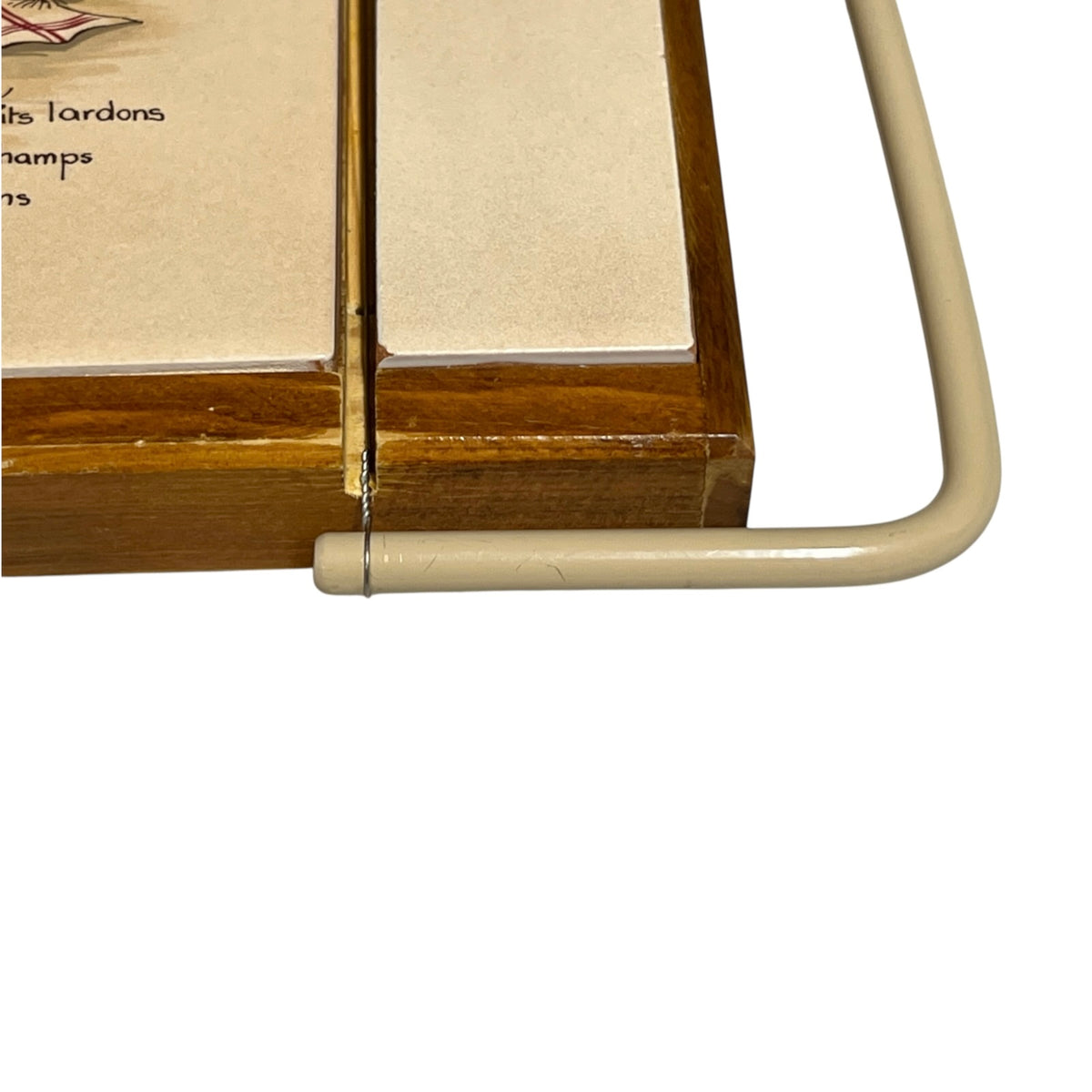 Close-up of a wooden and tile French cheeseboard on a white background 