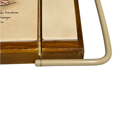 Close-up of a wooden and tile French cheeseboard on a white background 