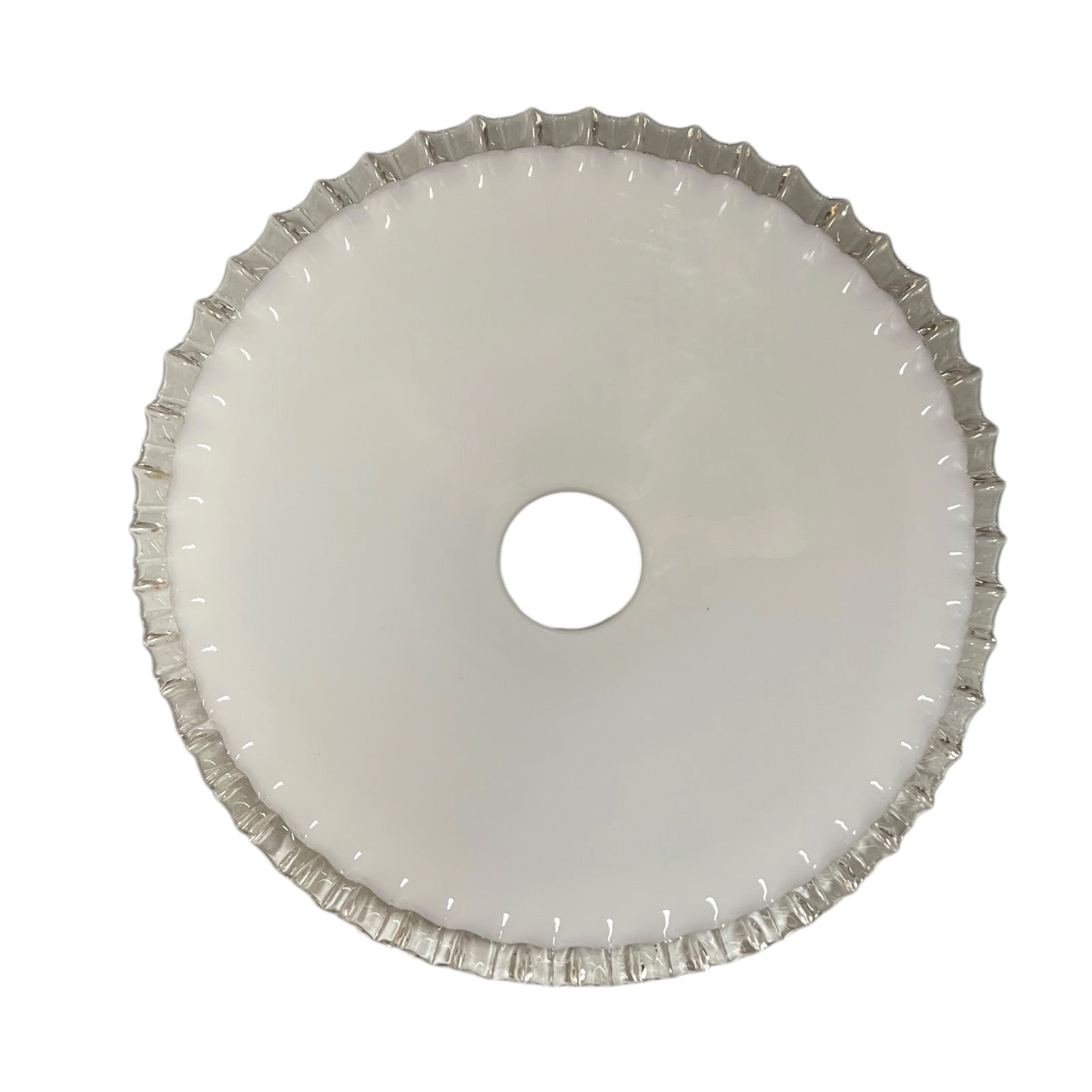 Inside view of a scalloped edged white glass lampshade on a white background