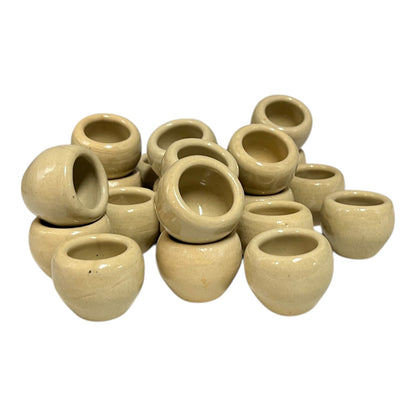 Set of beige ceramic escargots snail pots on a white background