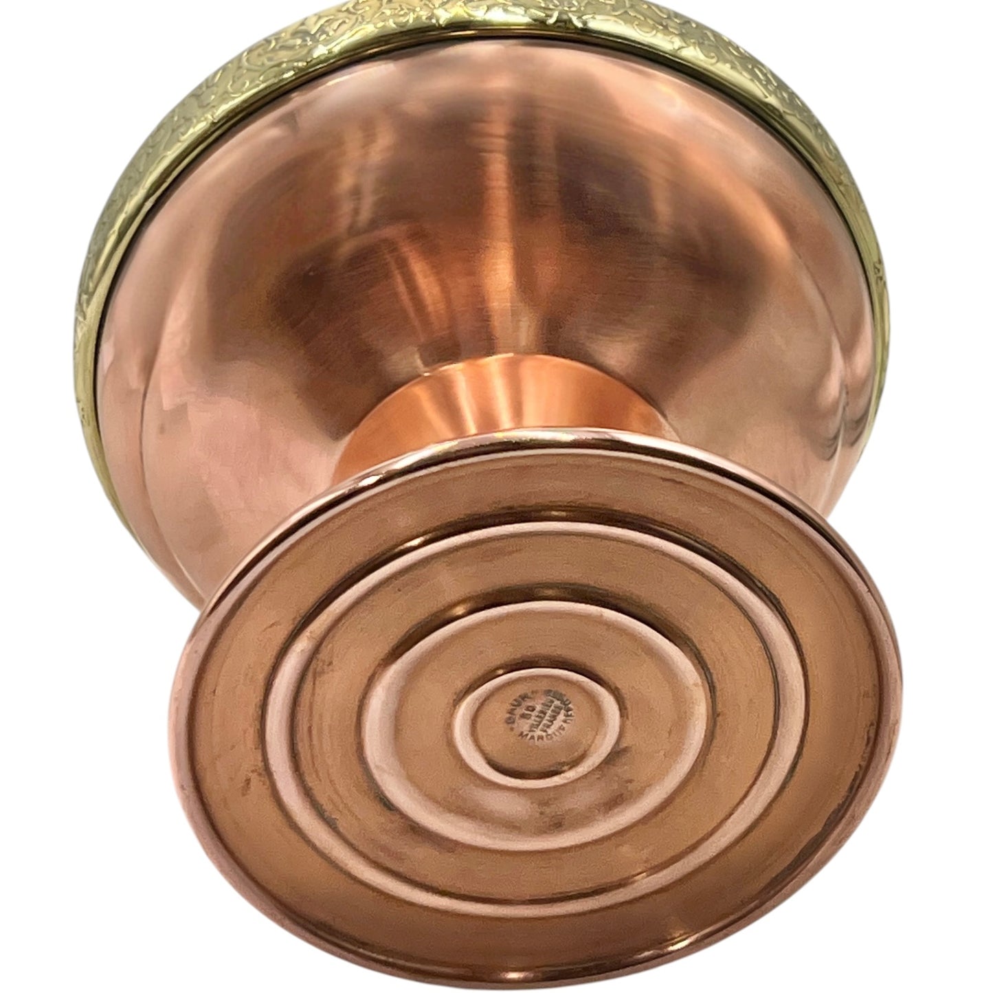 Copper and brass lamp base on a white background