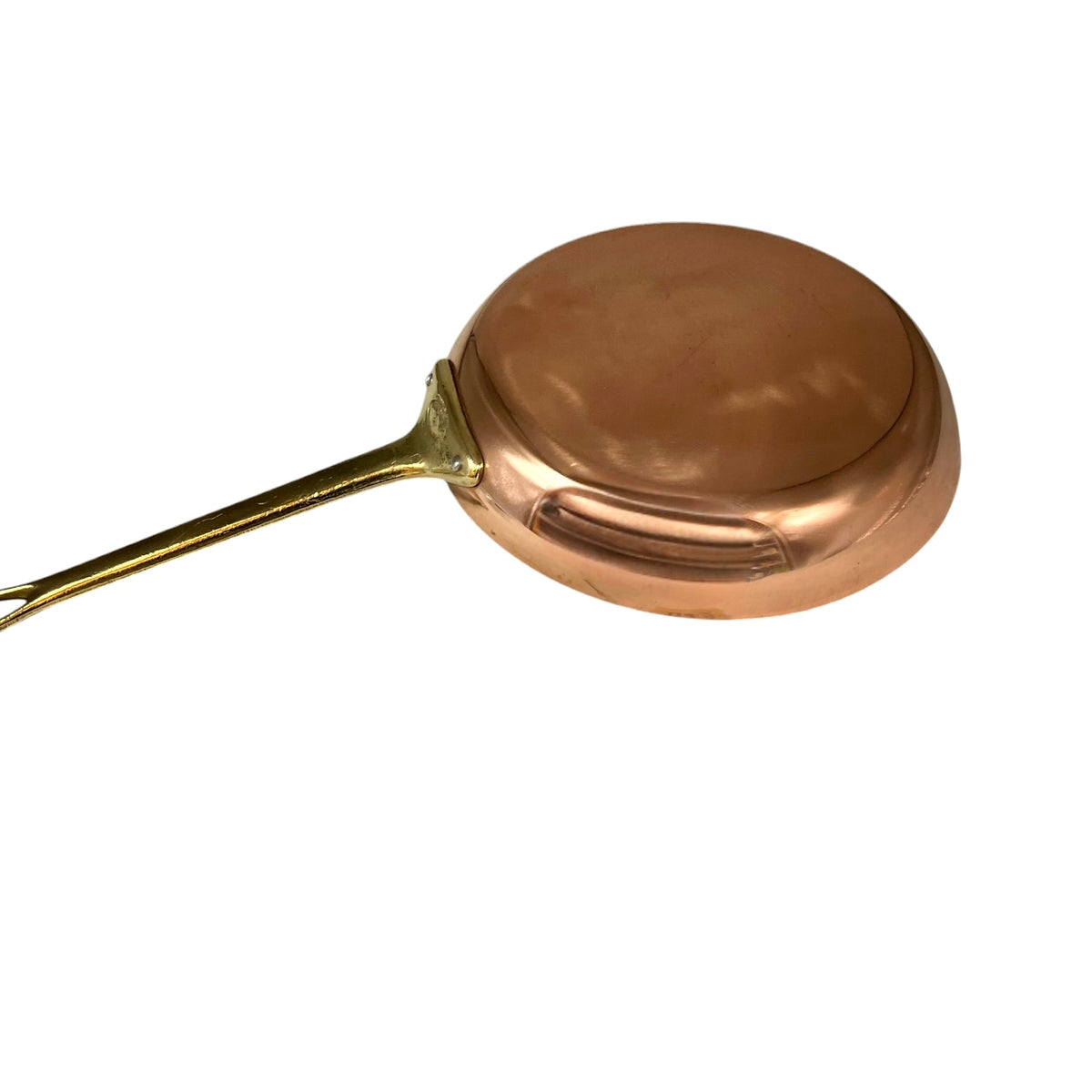 A copper metal pan with a gold-toned handle, shown from an elevated angle on a plain white background.