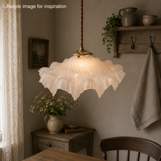 French vintage frosted glass frilled edge lampshade with a brass gallery collar in a rustic kitchen diner setting beside an open window 