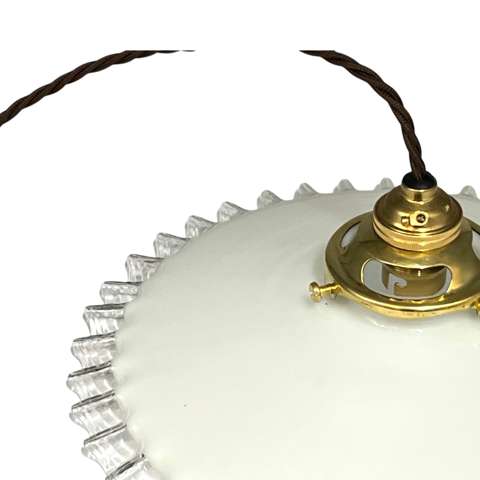 close up of brass ceiling light fixture with white glass shade on a white background