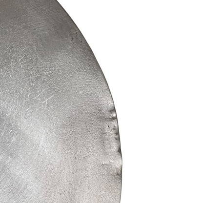 Close up French copper pan lid showing hand wiped traditional new tin lining  on a white background