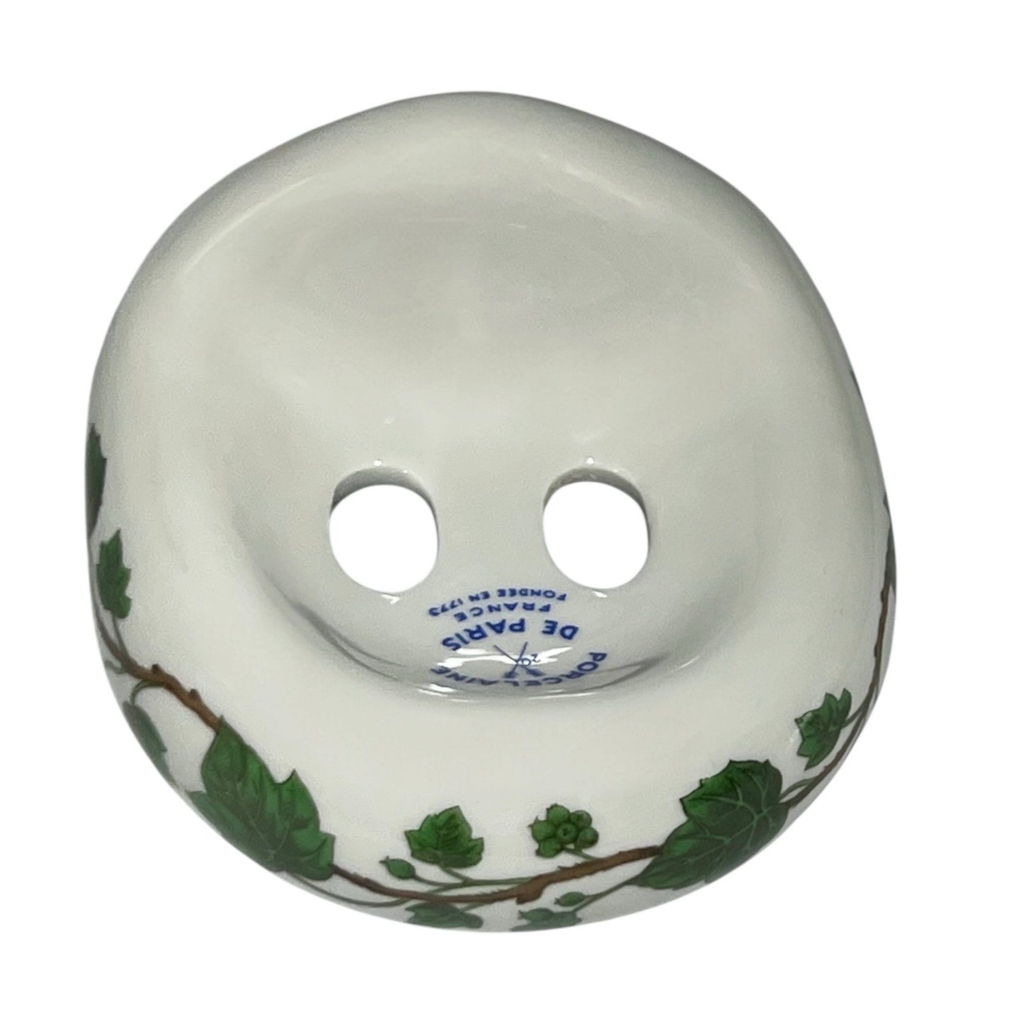 Porcelain bathroom toothbrush holder  featuring green leaf patterns on a white background