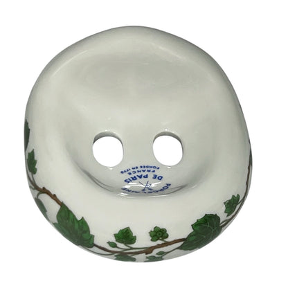 Porcelain bathroom toothbrush holder  featuring green leaf patterns on a white background