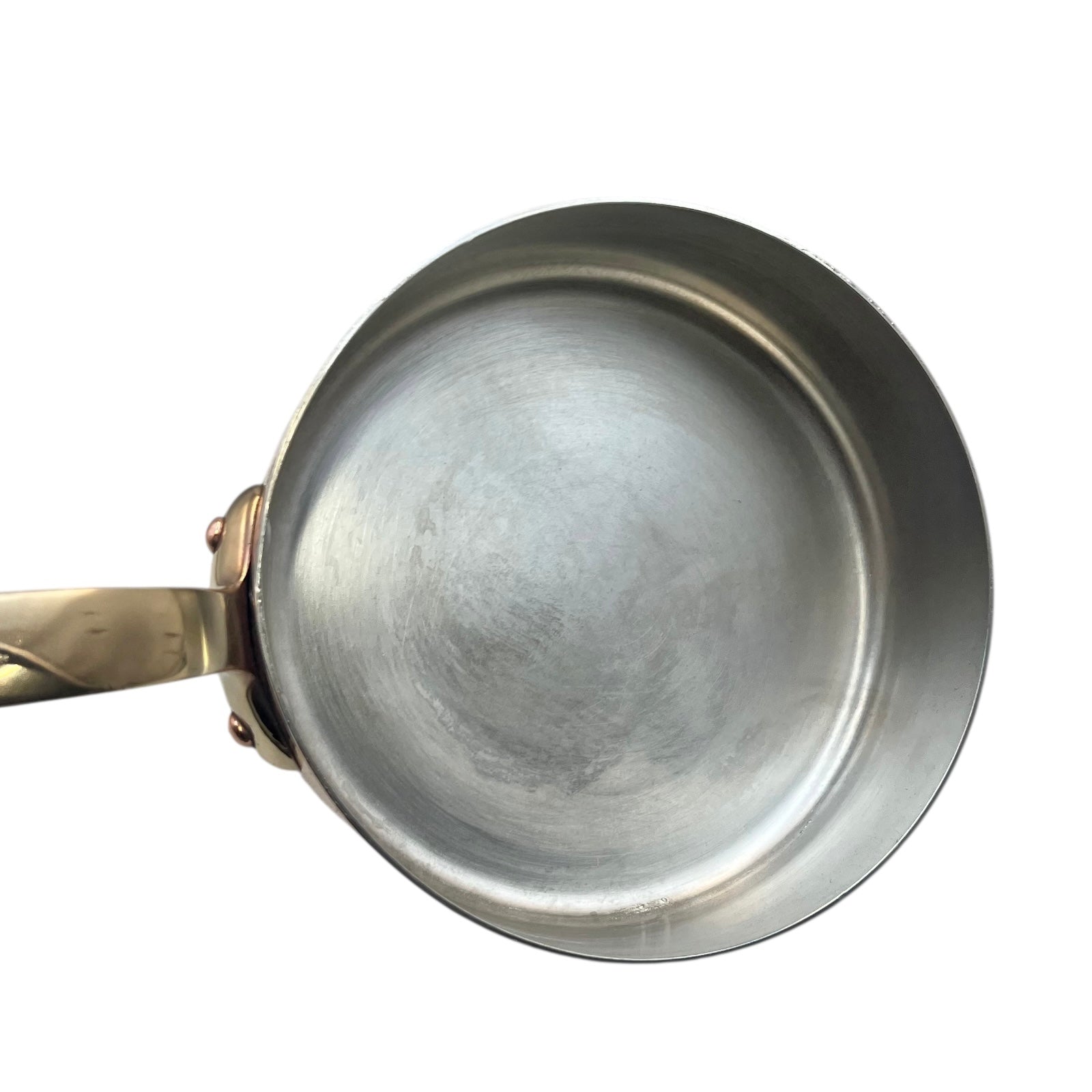Small copper frying pan with a brass handle and tin lining on a white background