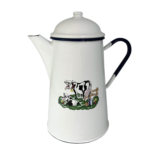 White enamel coffee pot with cow design on a white background