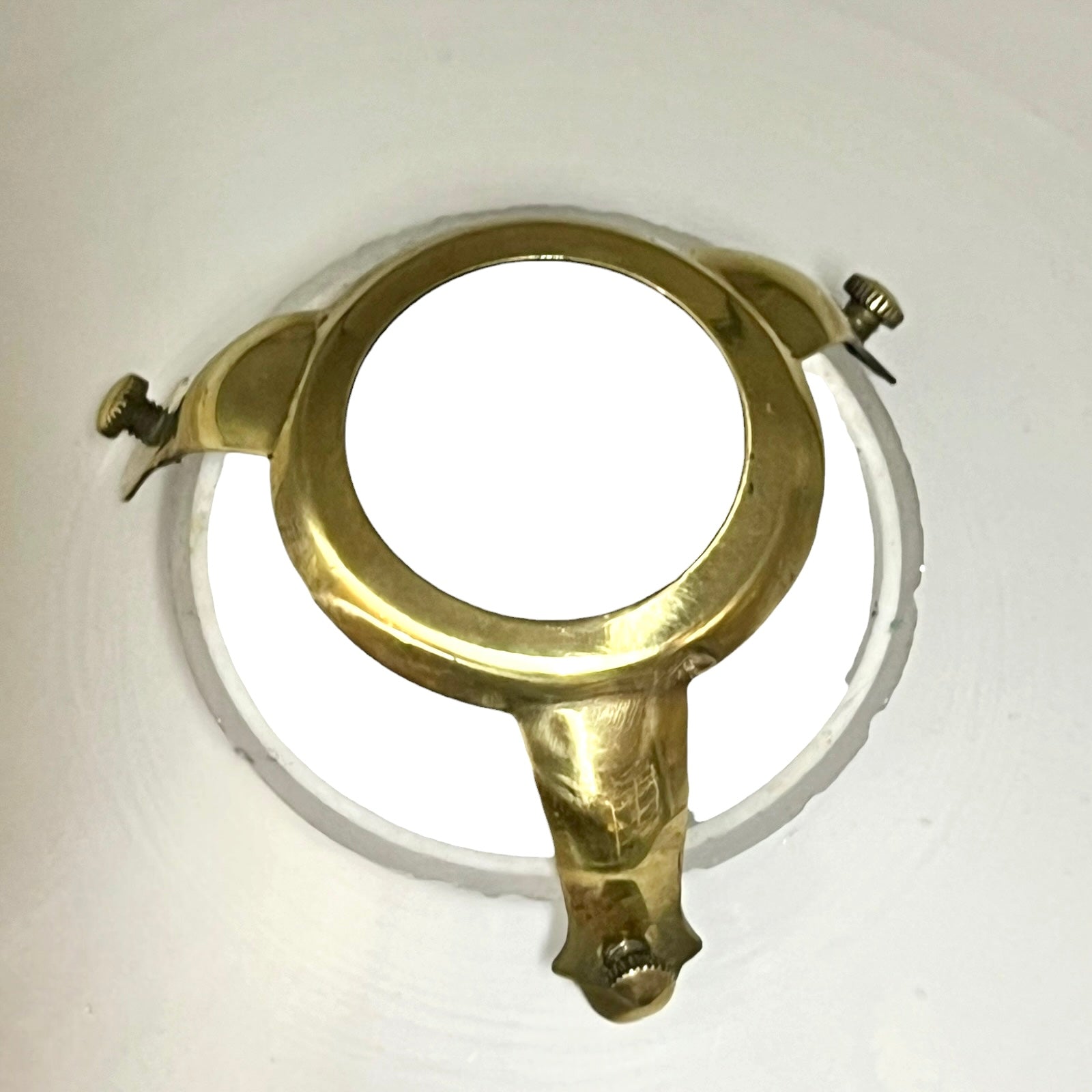 Brass ring with two attachments on a white background