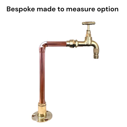 A brass deck mounted faucet with a cross handle, connected to copper pipes on a plain white background, with the text 'Bespoke made to measure option' above it.