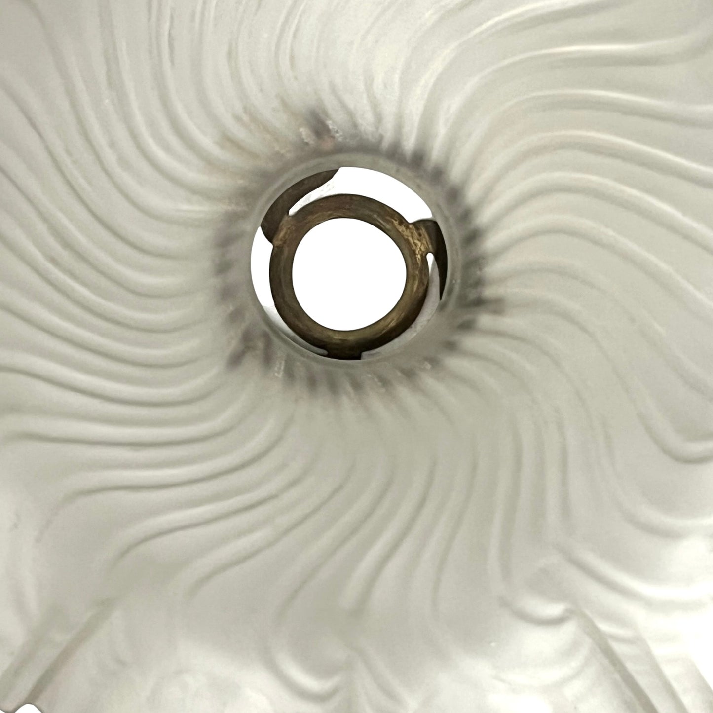 Close up of a glass lampshade on a white background 