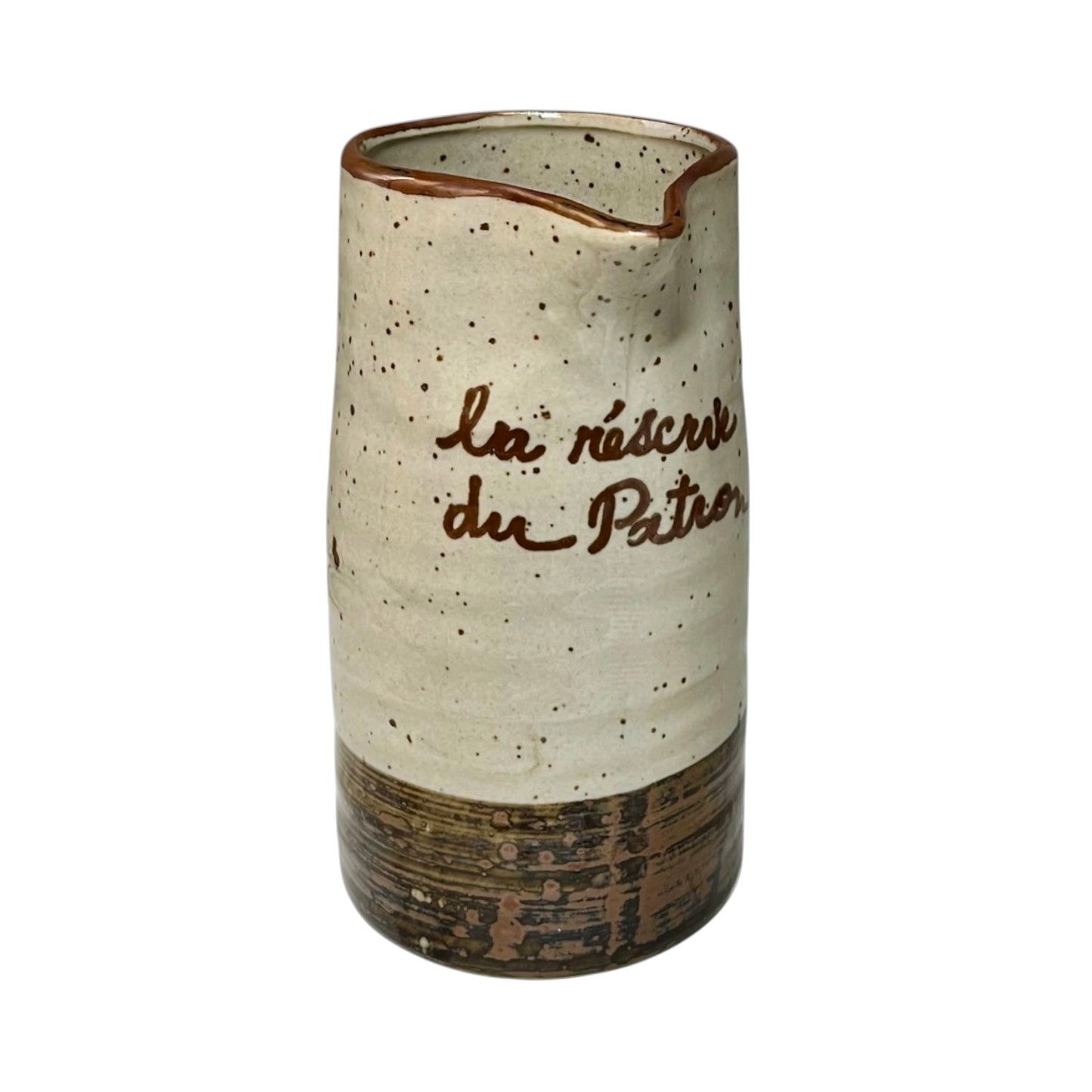 Ceramic speckled brown and cream vase with French text on a white background