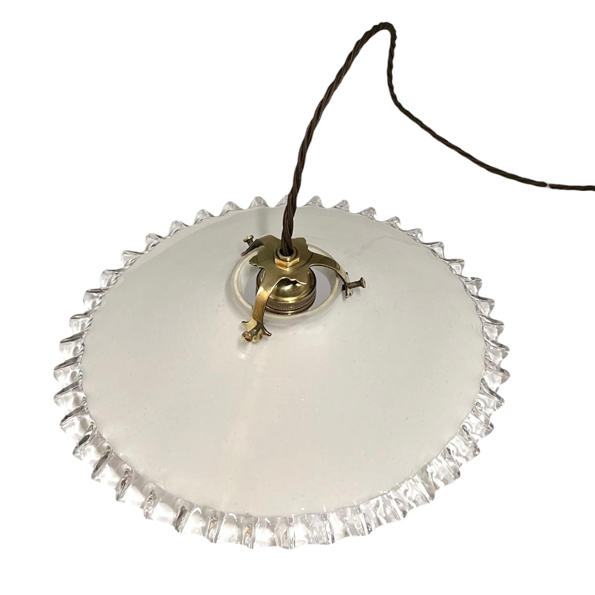 A round white glass ceiling light shade with a textured, fluted edge and a brass-colored metal fixture, suspended by a black cord against a white background.