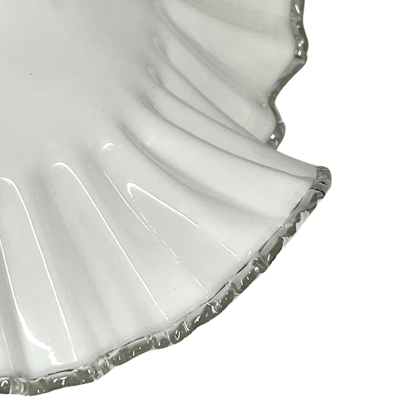 Close-up of a white lampshade with a scalloped edge on a white background
