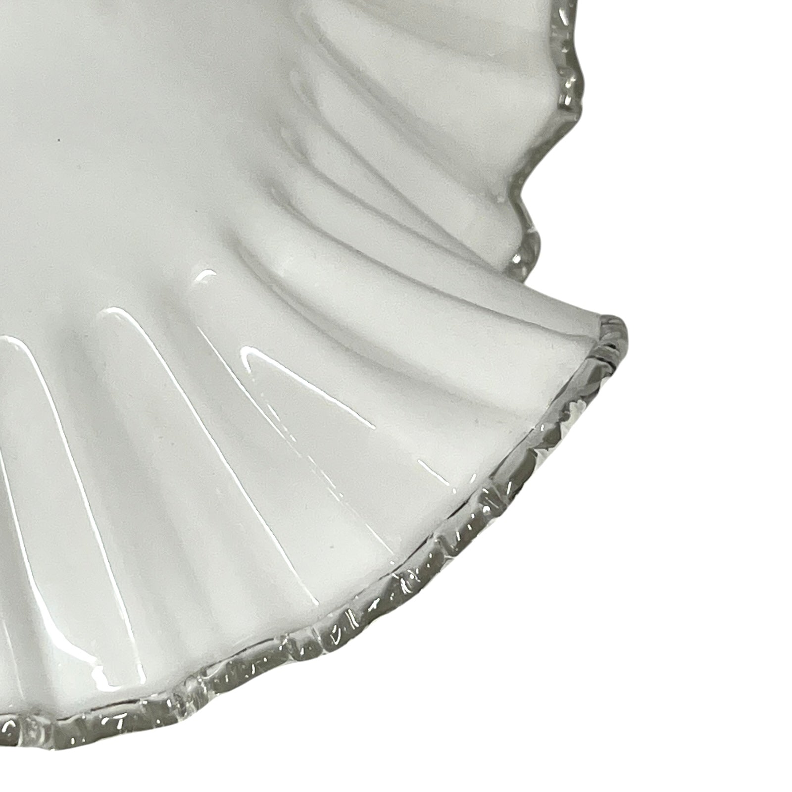 Close-up of a white lampshade with a scalloped edge on a white background