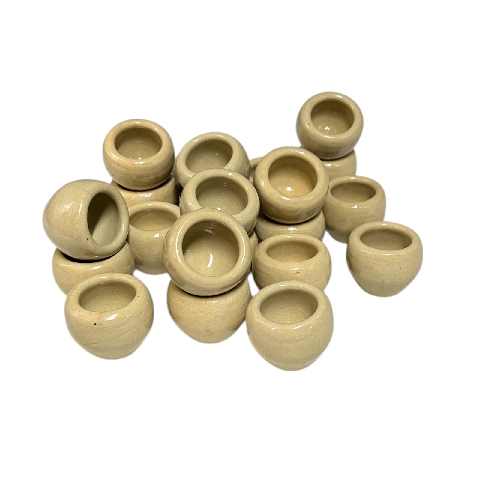 Set of beige ceramic escargots snail cups on a white background
