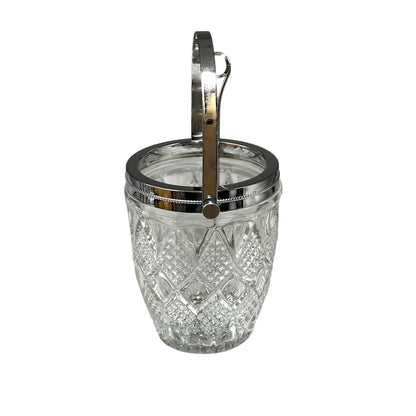 Clear glass ice bucket with silver scoop and handle on a white background