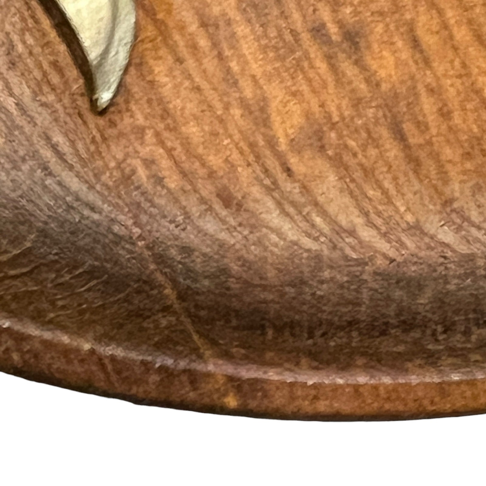 close up of a wooden decorative round plaque on a white background 