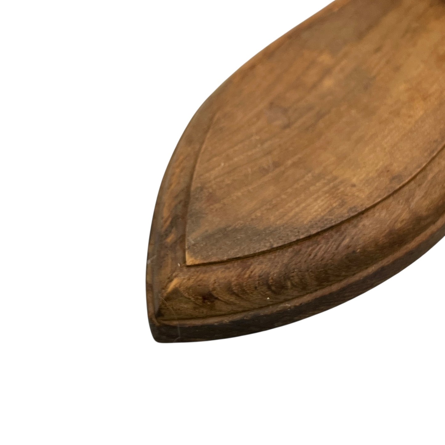 Close up of taxidermy deer hooves on a wooden mount on a white background