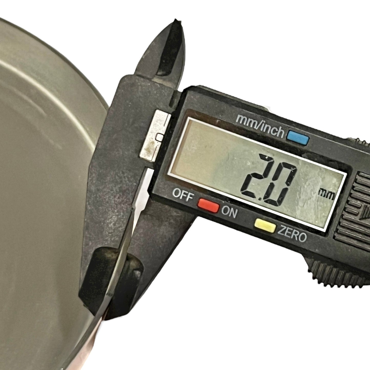 Digital caliper measuring a metal object with a digital display showing the measurement.