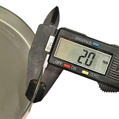 Digital caliper measuring a metal object with a digital display showing the measurement.