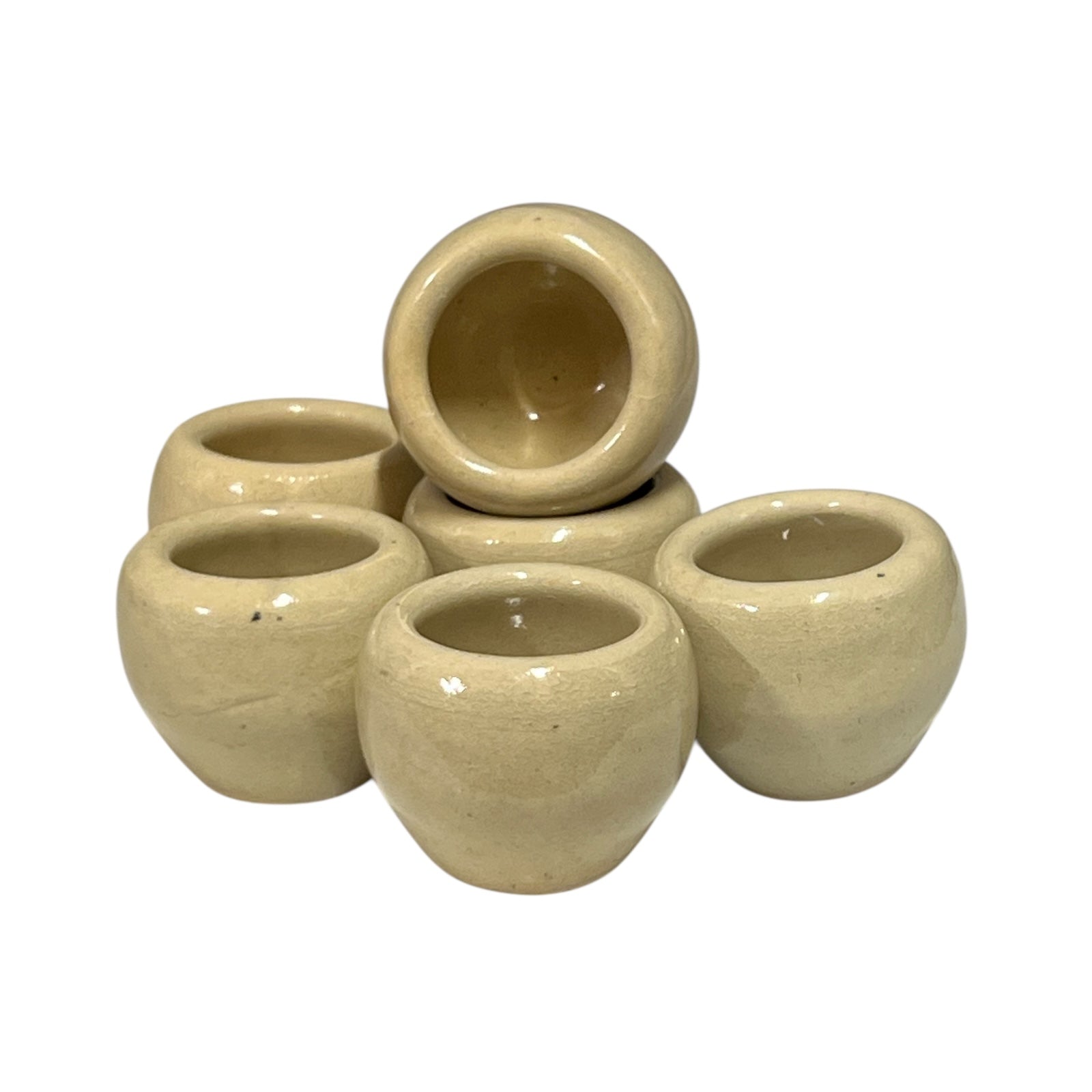 Set of beige ceramic escargots snail cups on a white background