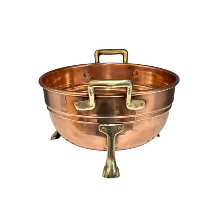Copper colander with brass handles and feet on a white background