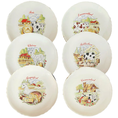 Set of ceramic cheese plates with farm-themed designs on a white background