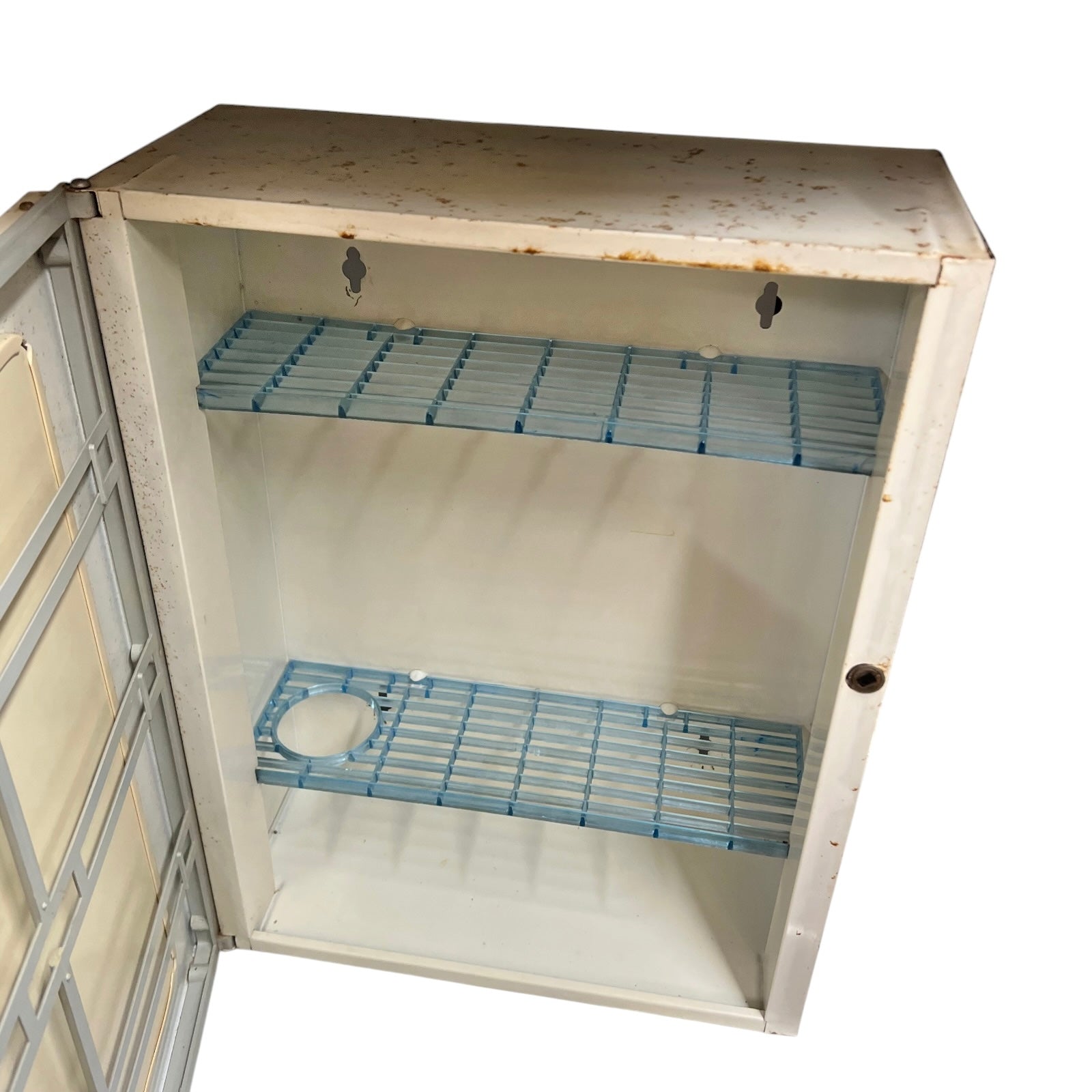 close up of a vintage metal bathroom cabinet inside view on a white background