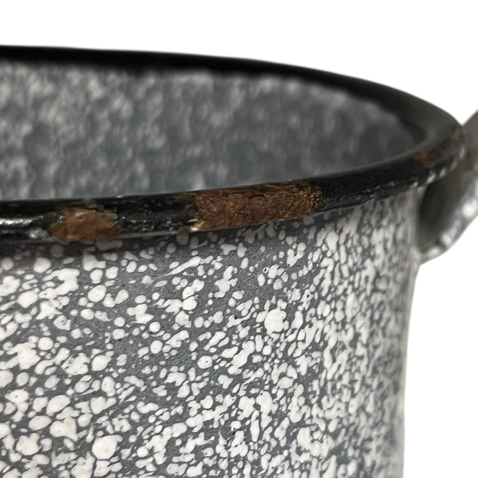 close up of vintage French grey and white speckled irrigator with a spout and a handle showing wear and tear on a white background