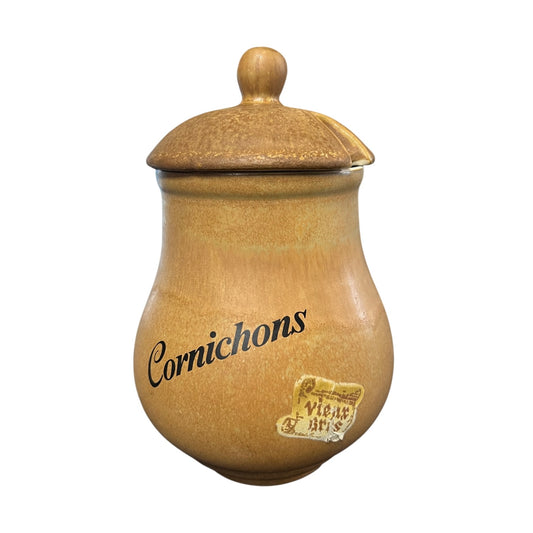 Stoneware jar with a lid labelled 'Cornichons' on a white background