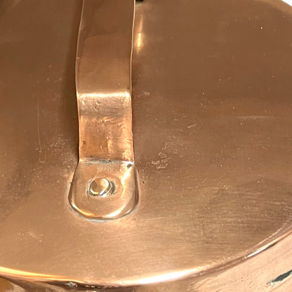 Close up of a copper cooking pot stockpot with handles on a white background