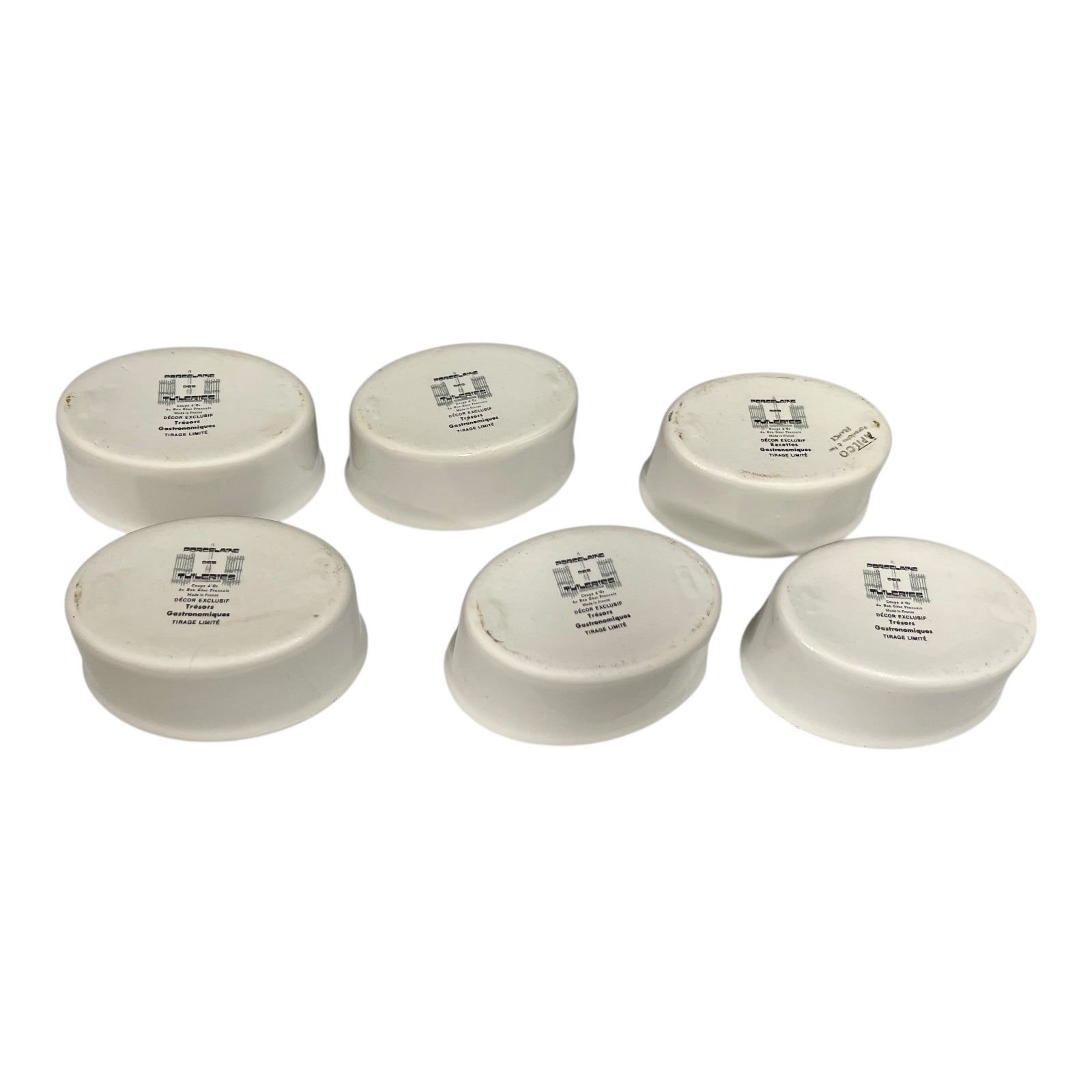 Six white ramekins with labels on a white background