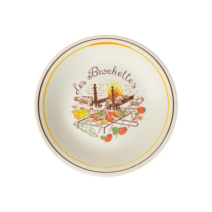 Decorative plate with 'Les Brochettes' design on a white background