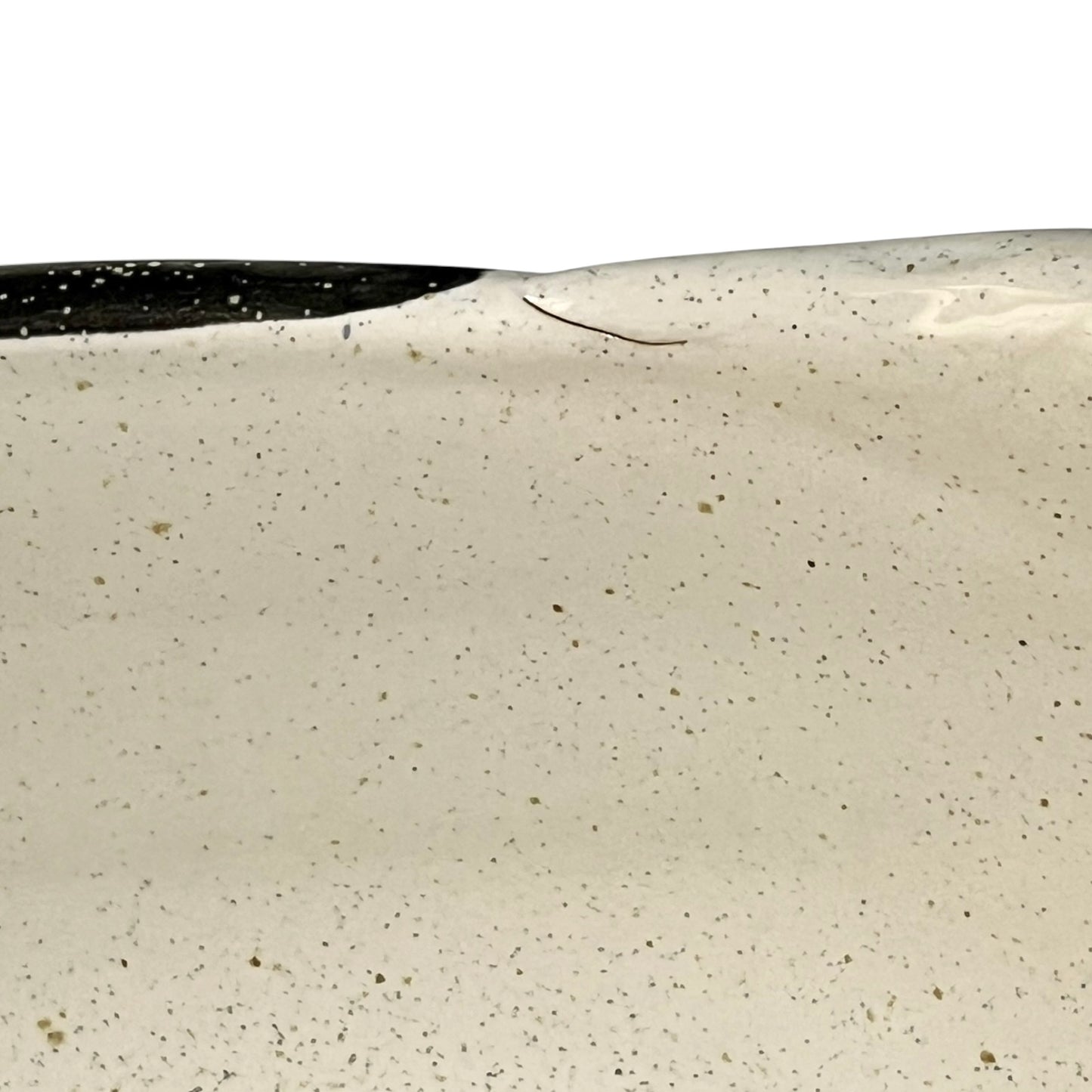 Close-up of a speckled ceramic bowl with a black rim on a white background