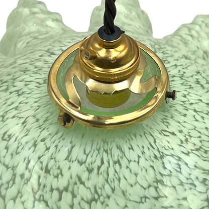 close up of light green milk glass pendant shade on a white background