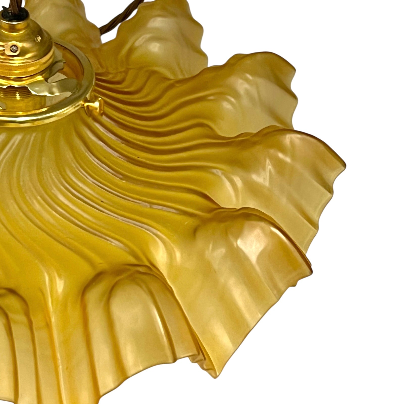 close up of amber coloured vintage French  pendant light with a scalloped design on a white background