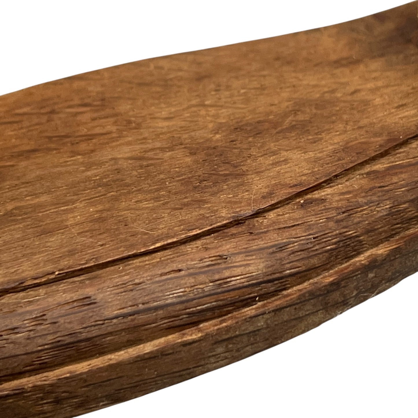 Close up of taxidermy deer hooves on a wooden mount on a white background