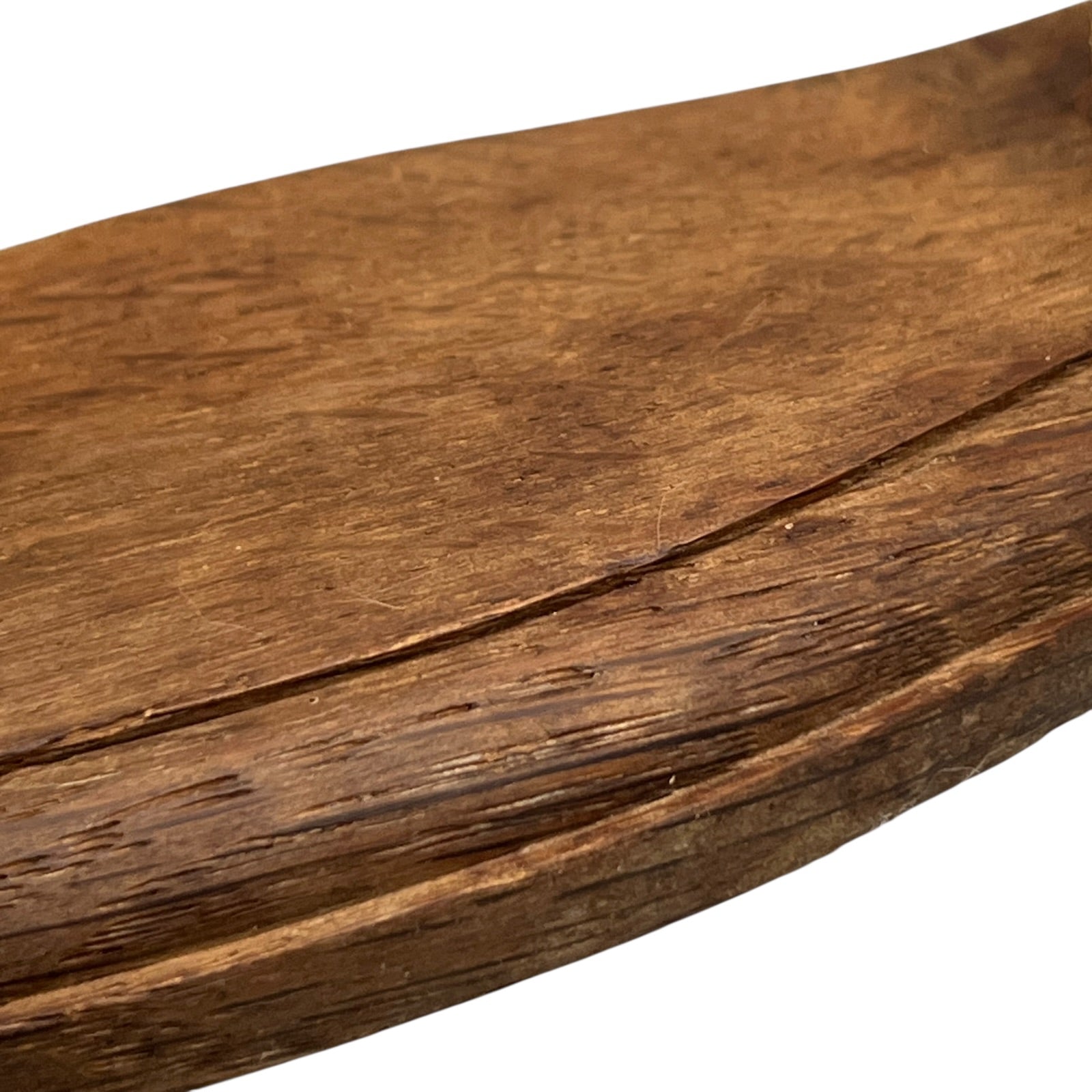 Close up of taxidermy deer hooves on a wooden mount on a white background