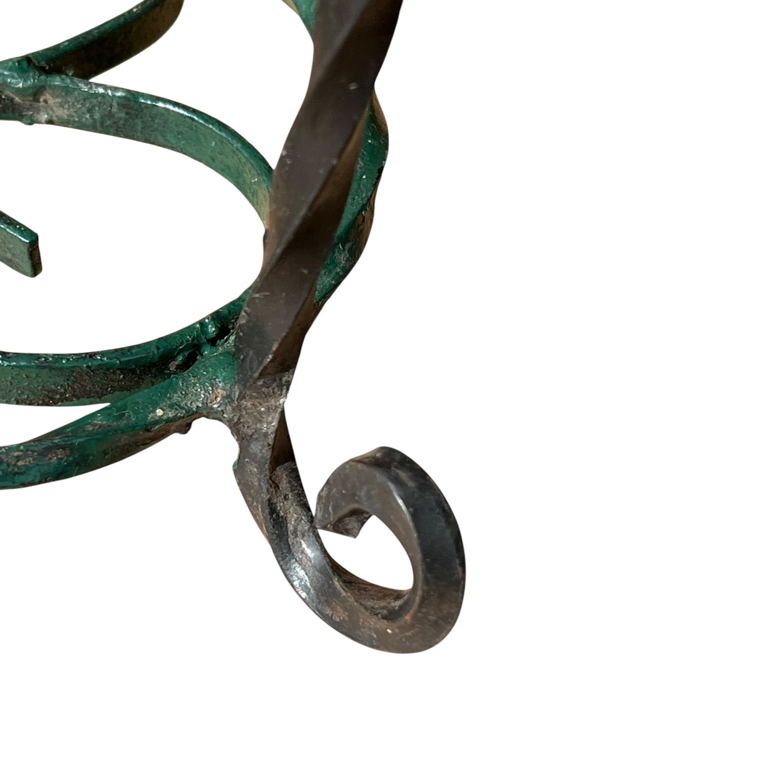 Close up of a wrought iron vintage plant stand on a white background 