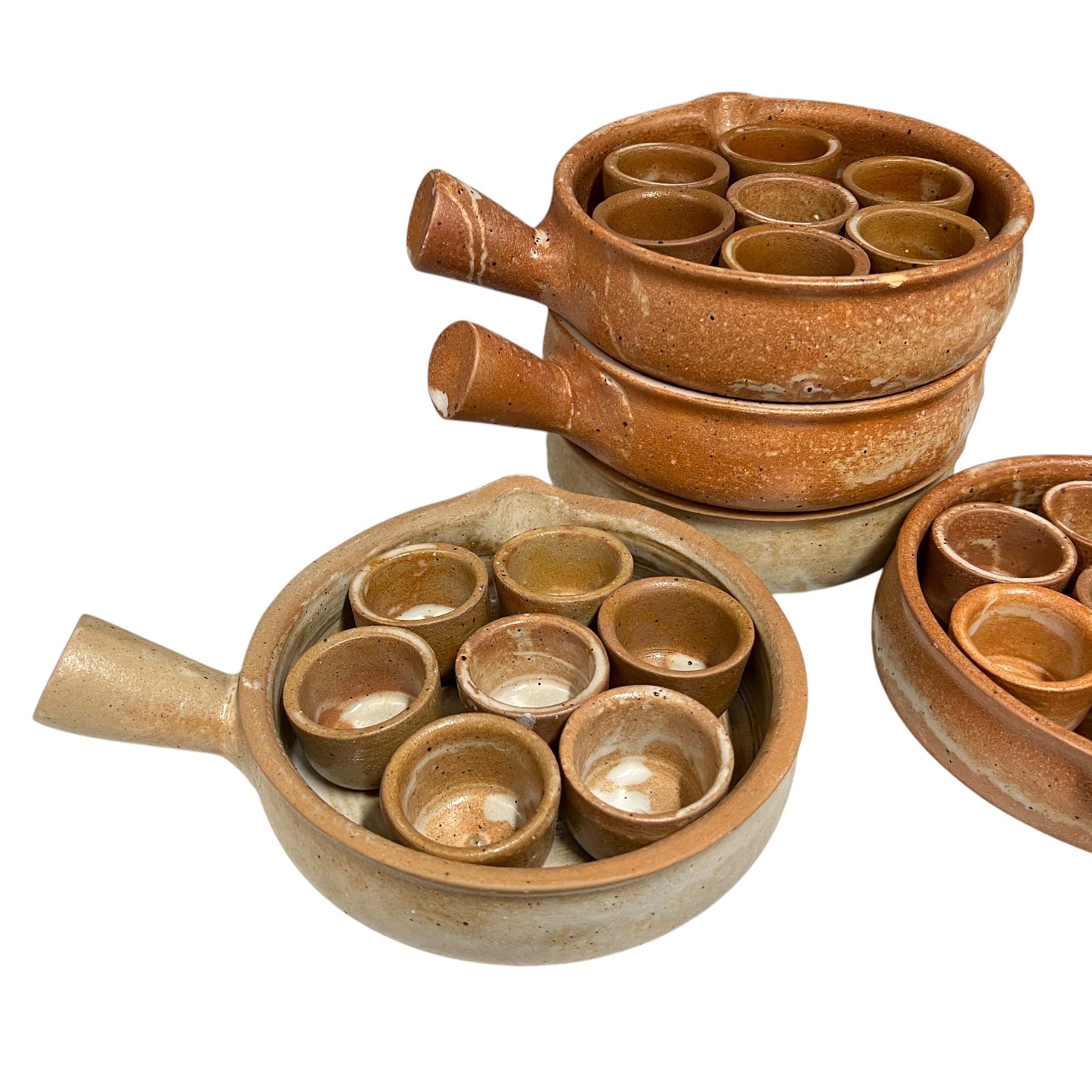 A set of terracotta clay pot holders with nested small cups, shown in multiple sizes and stacked on a white background.