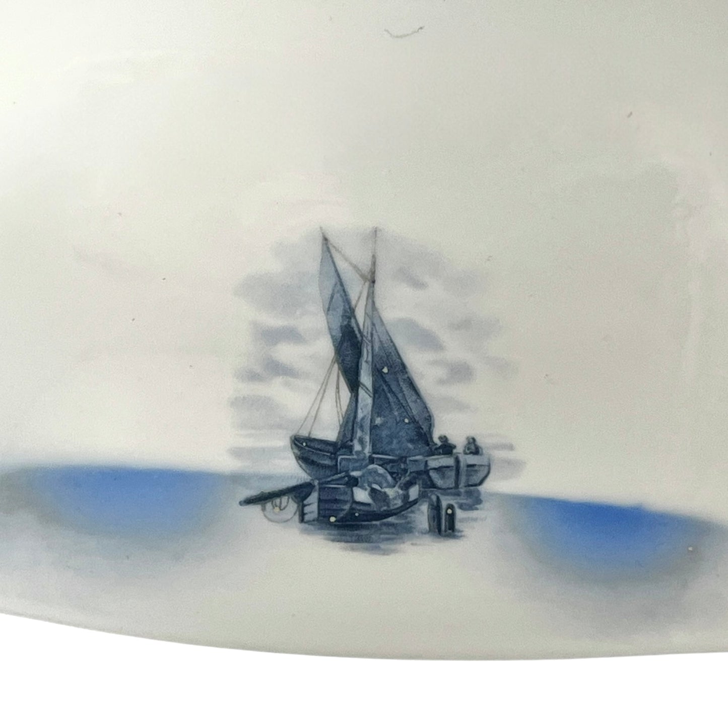 Close up of a white glass lamp shade with decorative design on a white background